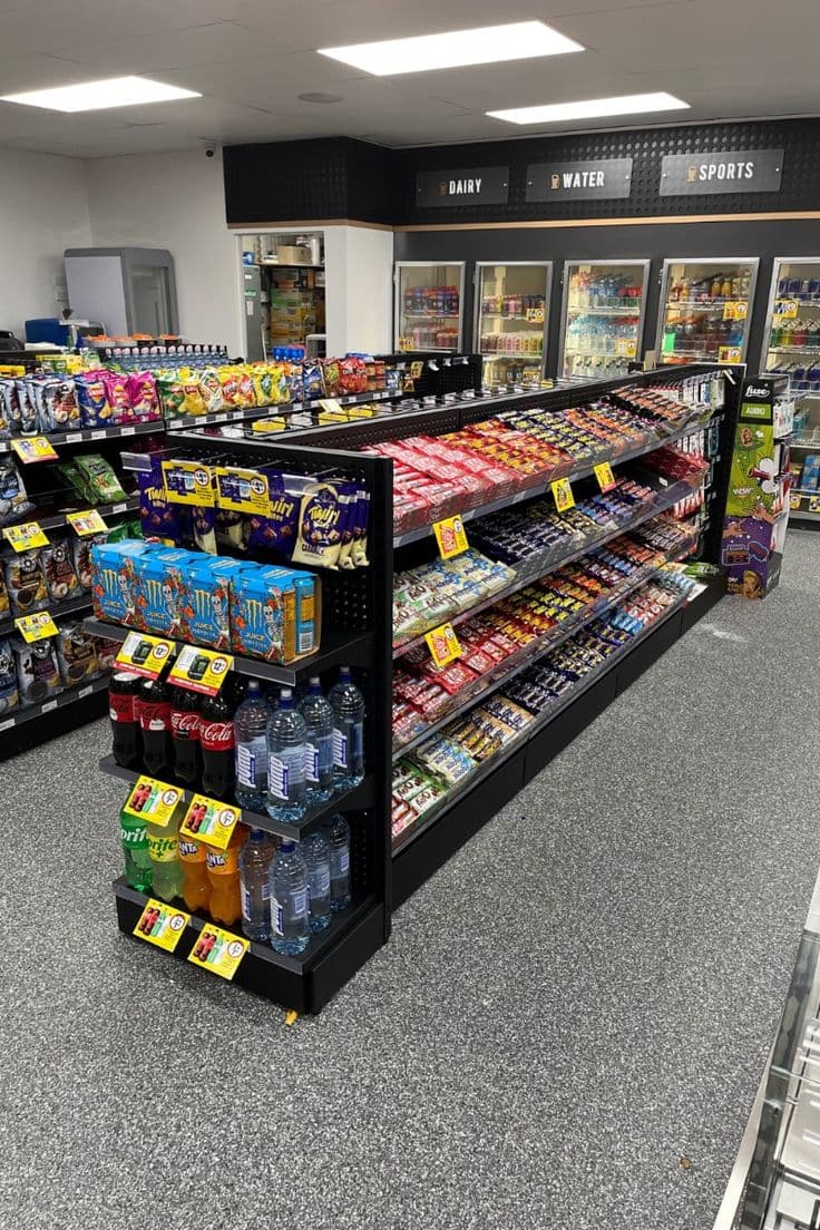 A well-stocked convenience store aisle of snacks and drinks